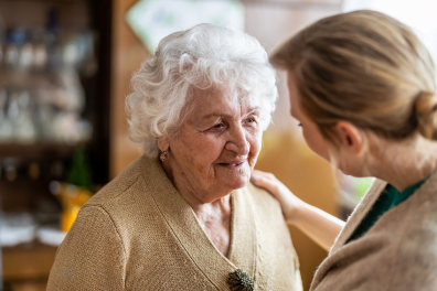 Elderly woman being comforted